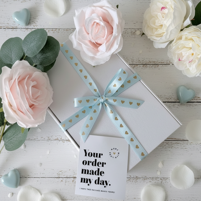 White gift box tied with blue heart ribbon bow pamper gift UK