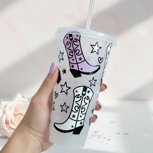 Cowboy boots 24oz cold cup with pastel pink and purple western design, UK handmade drinkware gift held in hand showing personalised graphics with stars and hearts