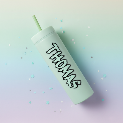 Personalised mint green cold cup with custom name, handmade in UK, lying flat on dreamy pastel gradient background with scattered star confetti