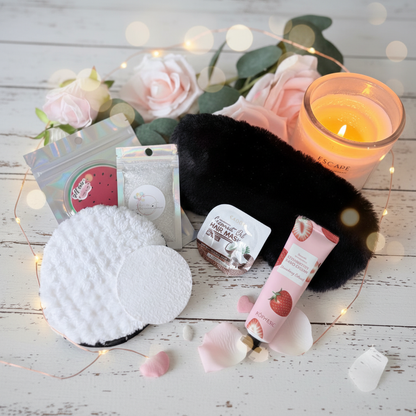 Luxury pamper gift box contents including reusable watermelon cooling eye pads, expanding face lather pad, reusable face sponge, coconut oil hair mask, strawberry hand cream and sleep eye mask, handmade in the UK