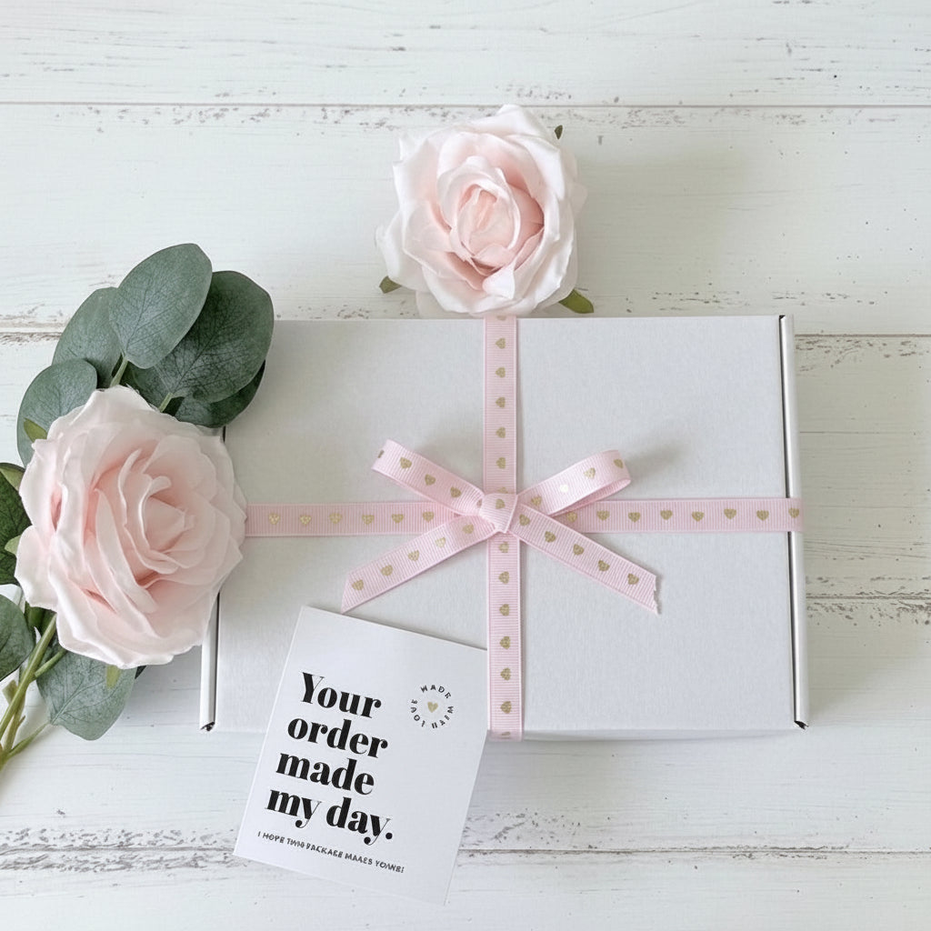 White gift box tied with pink heart ribbon UK