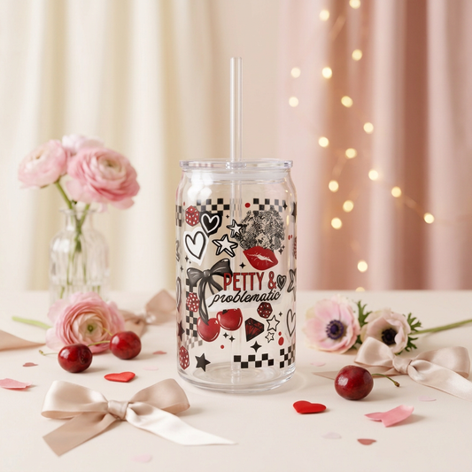 Petty and Problematic plastic can cup with black, white and red artwork, cherries, bows, clear lid and straw.