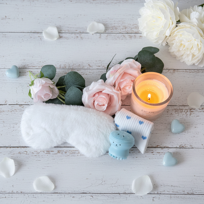White fluffy sleep eye mask, blue octopus facial cleansing brush and white heart socks pamper gift UK